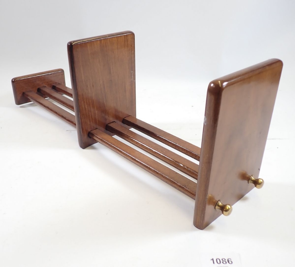 An extending wooden book rack, 55cm long