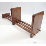 An extending wooden book rack, 55cm long