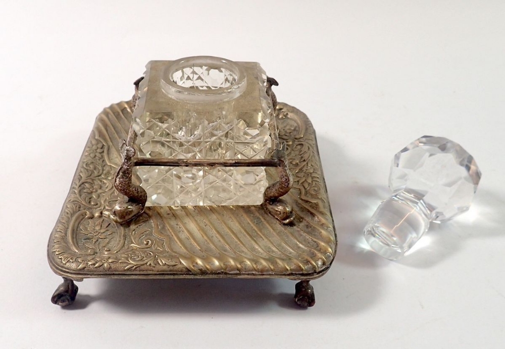 A cut glass inkwell in silver plated stand with dolphin supports, 11 x 13cm