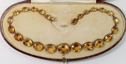 A Victorian gold necklace set oval yellow stones (possibly citrines) with fold in fitting for