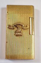 A Caran D'ache gold plated lighter with applied crest