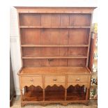 A 19th century oak and pine Welsh dresser with three tier back over three drawers, shaped apron