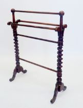 A Victorian rosewood finish towel rail on spiral turned supports
