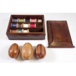 A Victorian mahogany cotton reel box with sliding lid, 14 x 19cm and three marquetry darning eggs