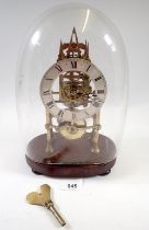 A 19th century skeleton clock with steeple movement and matched glass dome, 29cm tall