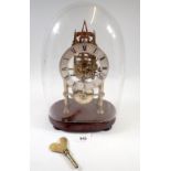 A 19th century skeleton clock with steeple movement and matched glass dome, 29cm tall