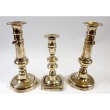 A pair of J Barlow patent brass candlesticks and another Georgian candlestick, 22cm