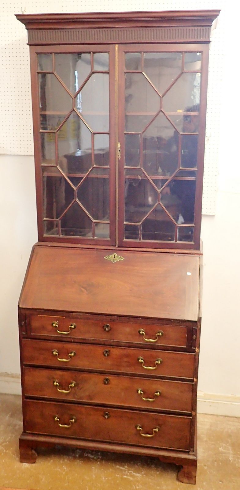 A Georgian mahogany bureau bookcase of small proportions with astragal glazed doors over slope front