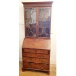 A Georgian mahogany bureau bookcase of small proportions with astragal glazed doors over slope front