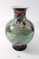 A Chinese famille noir bulbous vase painted warriors attending a Royal Palace, 26cm