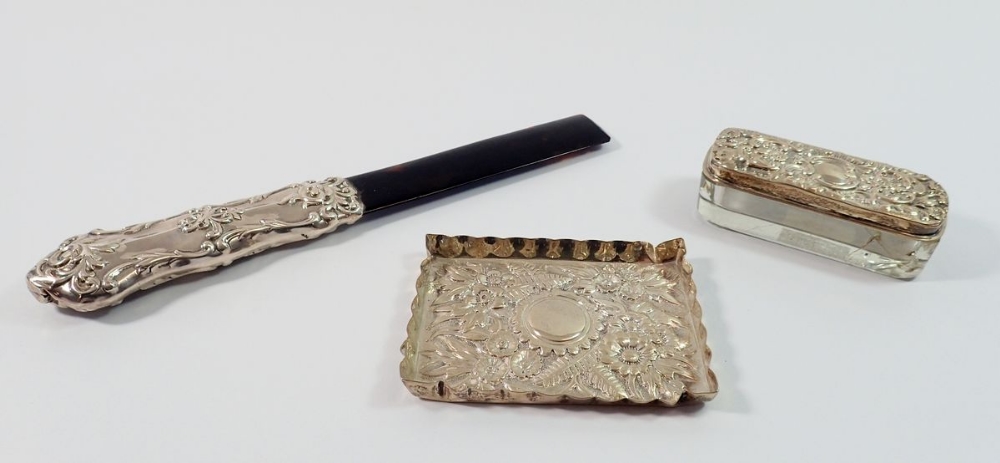 A silver floral embossed pin tray 7 x 9.5cm 37g, London 1892, a glass dressing table box with silver