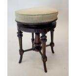 A Victorian Aesthetic style ebonised revolving piano stool with walnut inlay