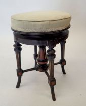 A Victorian Aesthetic style ebonised revolving piano stool with walnut inlay