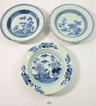 Three Chinese 18th century blue and white bowls painted flowers and garden scenes, 23cm diameter