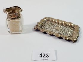 A silver miniature pin tray, 10 x 7cm and a glass and silver smelling salts bottle