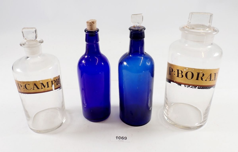 Two labelled glass chemists jars and two Bristol blue apothecary bottles, tallest 21cm