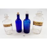 Two labelled glass chemists jars and two Bristol blue apothecary bottles, tallest 21cm