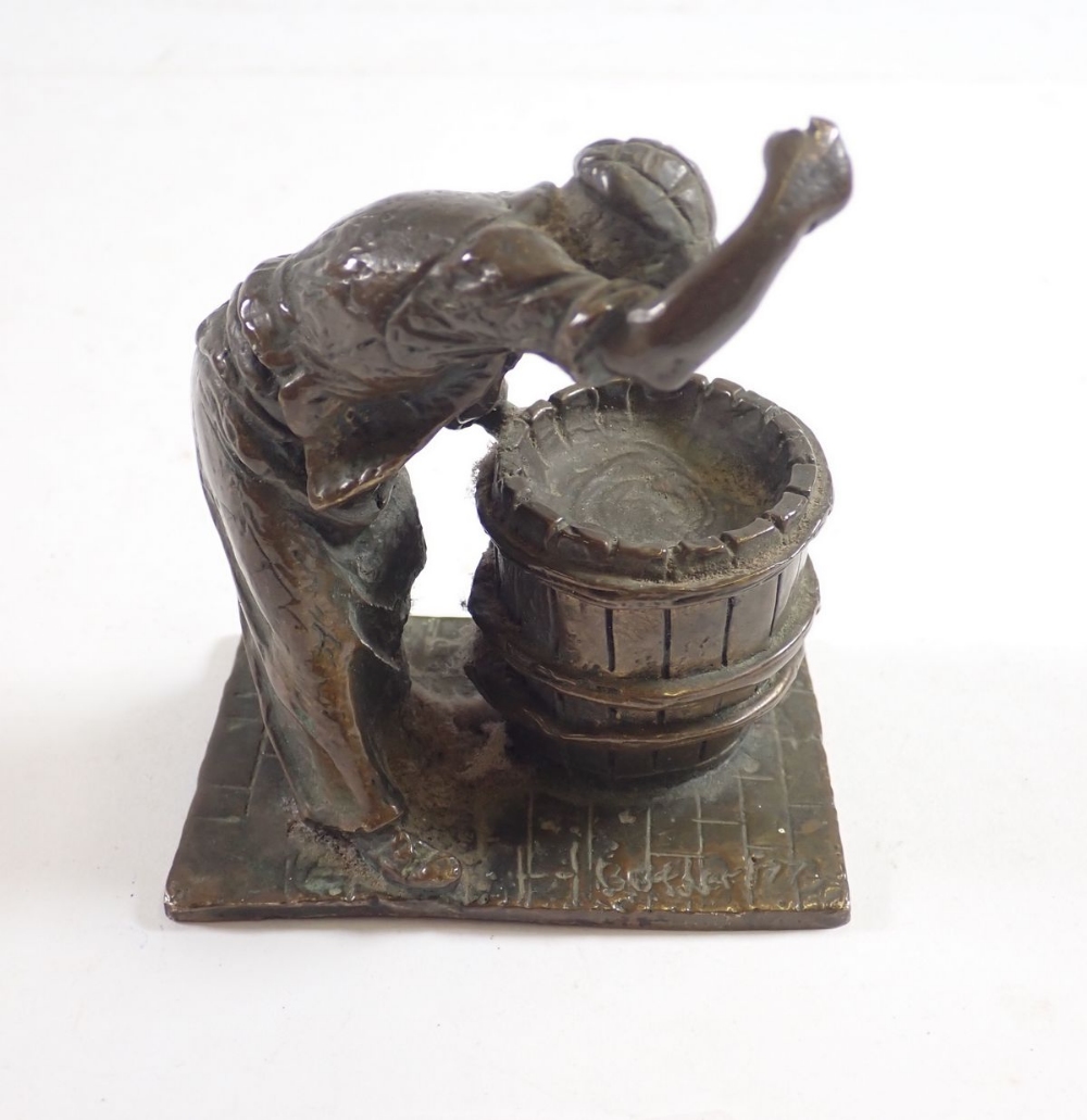 A small bronze figure of a barrel Cooper at work, 10cm tall signed Butler 77