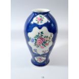 A blue and gold Worcester style vase with floral relief panels, base marked 877/4527, 27cm tall