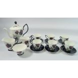 A Royal Albert Masquerade coffee set comprising coffee pot, six cups and saucers, milk and cream