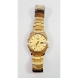 A Seiko 5 gents automatic wristwatch with gold dial and gold plated strap
