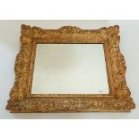 A 19th century heavy carved oak and gesso framed mirror with shell and foliage decoration, 48 x 56cm