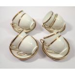 A Paragon set of eight gilt and white tea cups and nine saucers