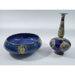 A Royal Doulton stoneware bowl with floral motifs on a blue ground and a similar long necked vase,