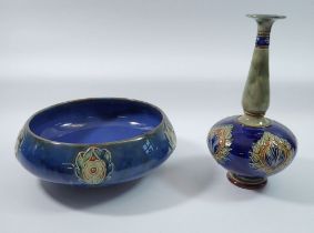 A Royal Doulton stoneware bowl with floral motifs on a blue ground and a similar long necked vase,