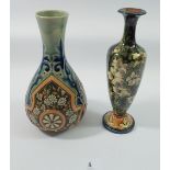 A Doulton Lambeth stoneware vase decorated flowers and blue scrollwork decoration and another