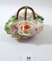 A continental porcelain floral encrusted basket, 11cm