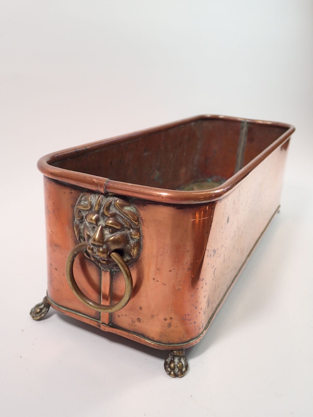 A copper plant trough 38cm long, a brass hammered tray, a miniature gurnsey and a brass bell - Image 2 of 2