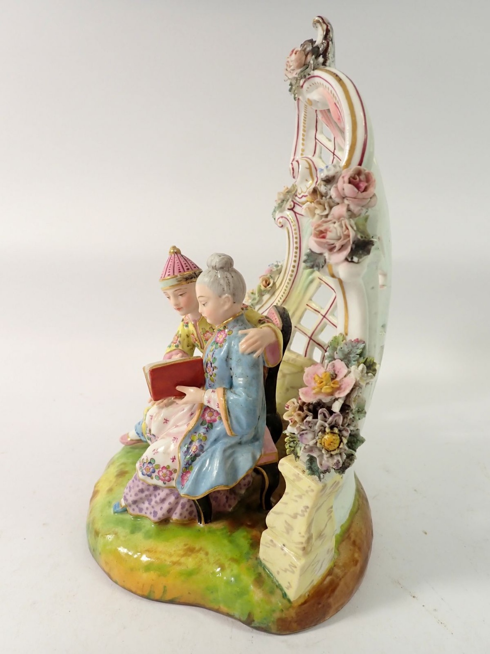 A 19th century Meissen style group of Chinese couple seated reading in floral and scrollwork - Image 5 of 6