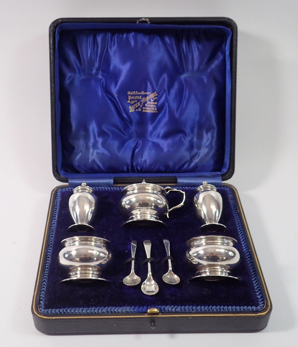 A silver five piece cruet set with original spoons and boxed, Birmingham 1911 by Deakin & Francis