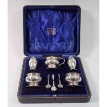 A silver five piece cruet set with original spoons and boxed, Birmingham 1911 by Deakin & Francis