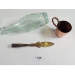 A copper Trench Art paperknife, a Royal Navy Copper measure with anchor mark to base and a glass