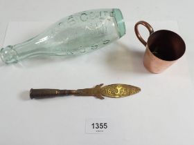 A copper Trench Art paperknife, a Royal Navy Copper measure with anchor mark to base and a glass