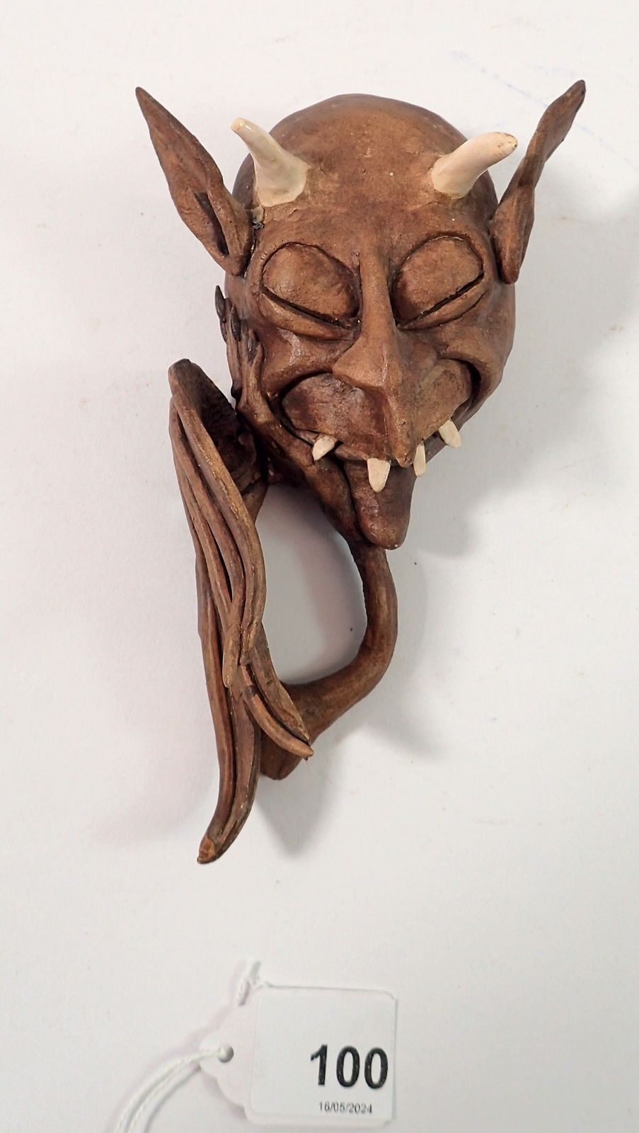 A Roger Roberts pottery devil mask wall plaque, 15cm