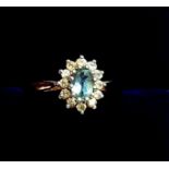 A 9 carat gold blue topaz and white stone cluster ring, size N, 1.5g