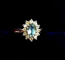 A 9 carat gold blue topaz and white stone cluster ring, size N, 1.5g