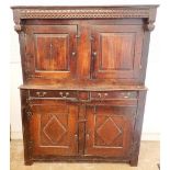 A 17th century oak court cupboard with two doors over drawers and two panelled cupboards, 140cm wide