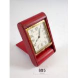 An Art Deco Jaeger le Coultre travel clock in red leather case