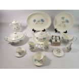 A Wedgwood Ice Rose dinner service comprising three serving platters, seven dinner plates, eight