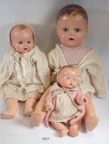 An early 20th century composition doll and two composition baby dolls, largest 53cm