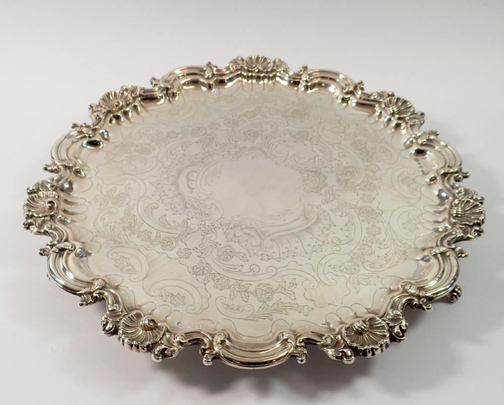 A Victorian silver pie crust edge large salver with engraved flower and scrollwork decoraton, on