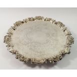 A Victorian silver pie crust edge large salver with engraved flower and scrollwork decoraton, on