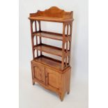 An early 20th century open oak bookcase with three shelves over cupboard, 60x128cm