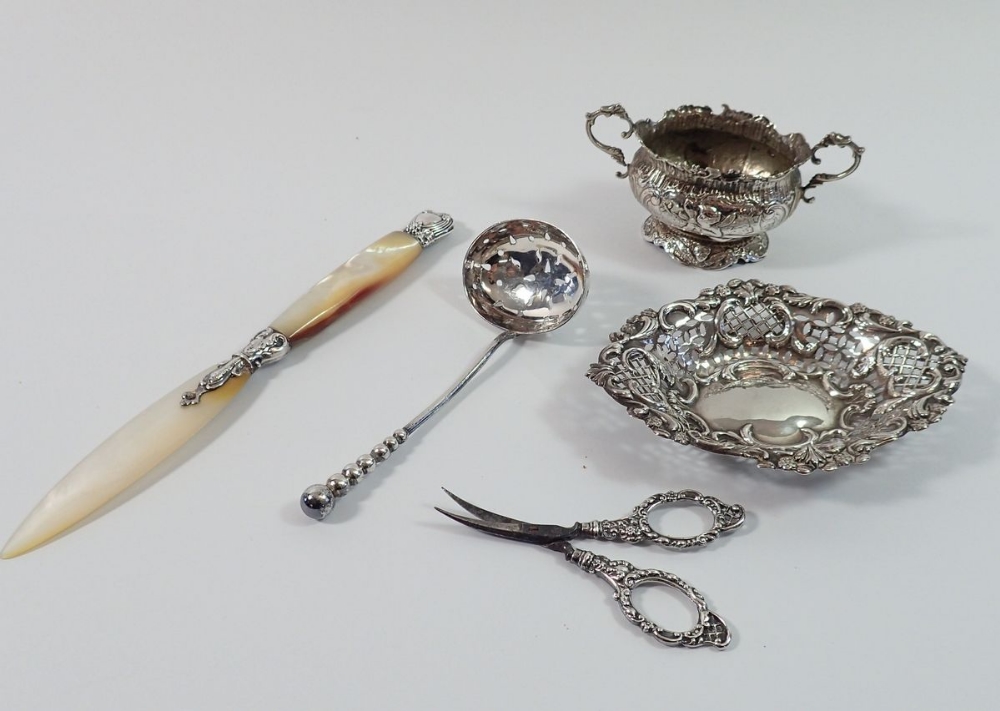 A silver pierced trinket dish, Birmingham 1886, silver scissors, Birmingham 1904, sifter spoon,