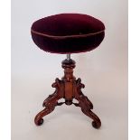 A Victorian large mahogany revolving piano stool on ornately carved base with triple scroll