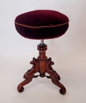 A Victorian large mahogany revolving piano stool on ornately carved base with triple scroll